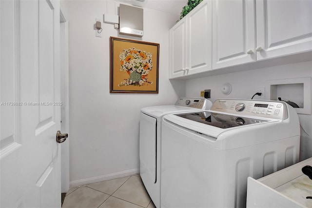 washroom featuring light tile patterned flooring, cabinets, and separate washer and dryer