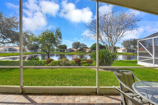 unfurnished sunroom with a water view