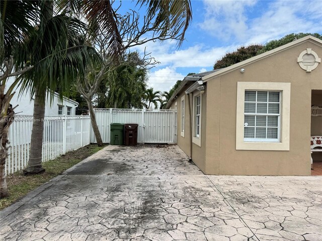 view of side of home with a patio area