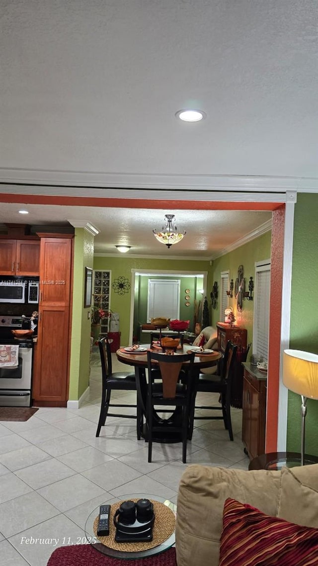 tiled dining area featuring crown molding