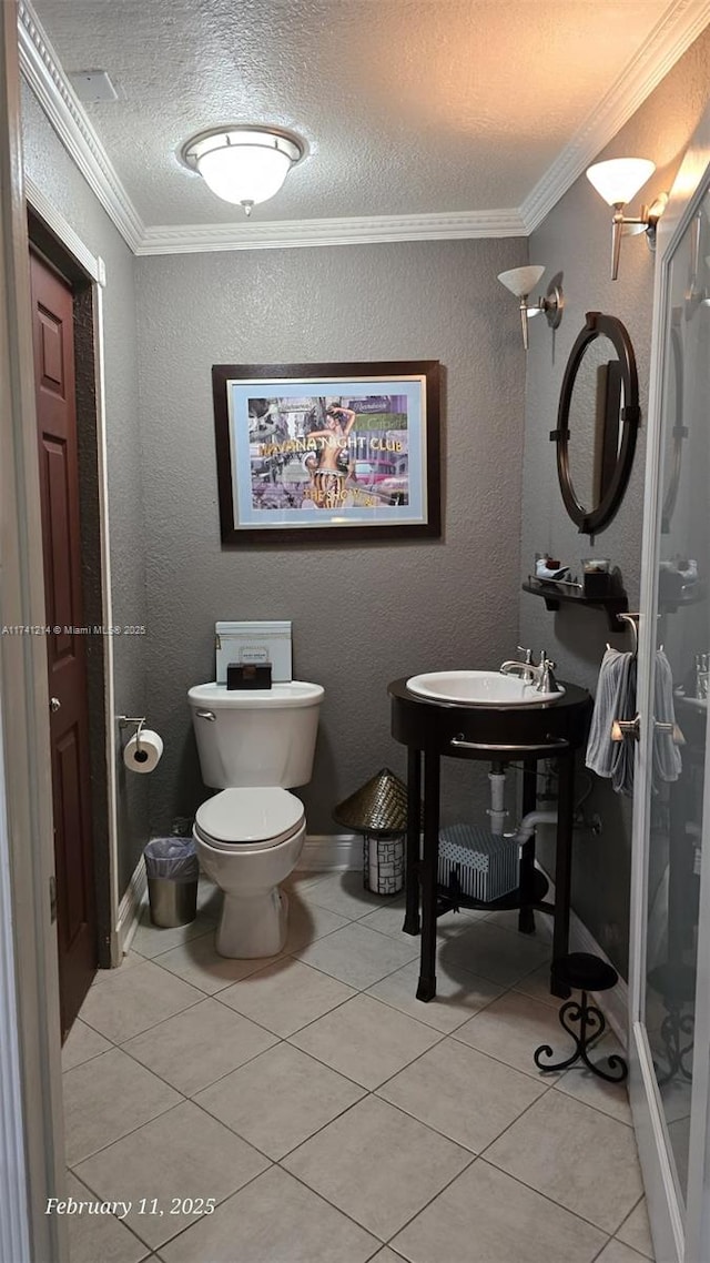 bathroom with tile patterned flooring, crown molding, a textured ceiling, and toilet