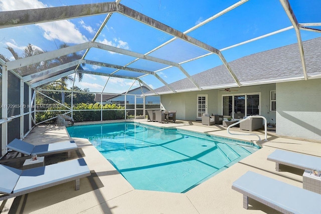 view of swimming pool featuring an outdoor living space, a lanai, and a patio area