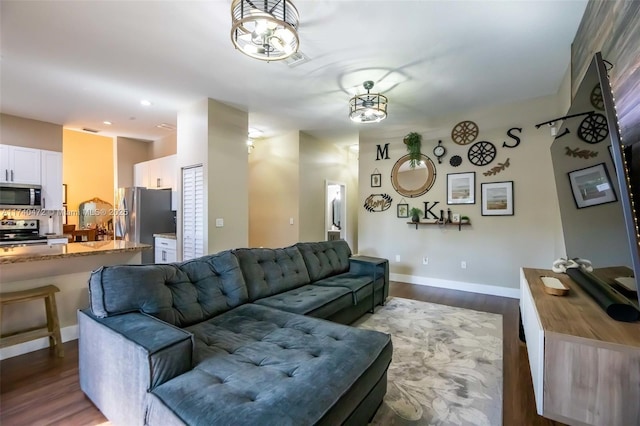 living room featuring an inviting chandelier and light hardwood / wood-style flooring