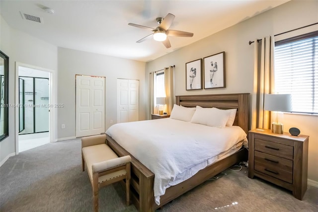 bedroom with multiple closets, light colored carpet, and ceiling fan