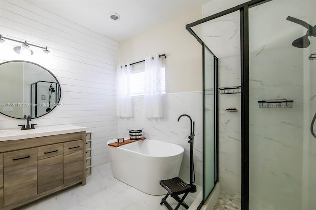 bathroom with vanity and independent shower and bath