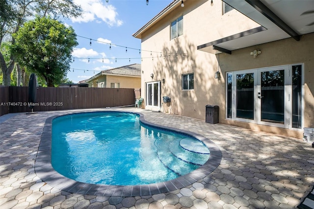 view of pool with a patio area and french doors