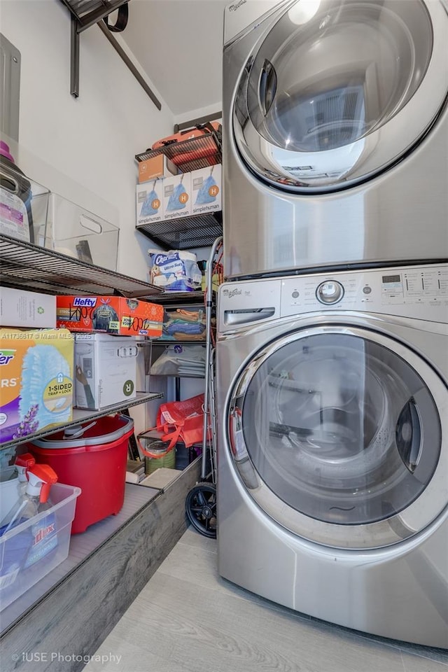 laundry room featuring stacked washer / drying machine