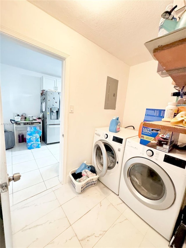 washroom with separate washer and dryer, electric panel, and a textured ceiling