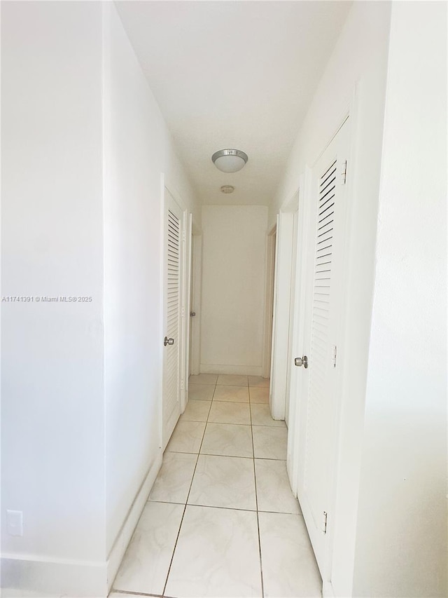 hallway featuring light tile patterned floors