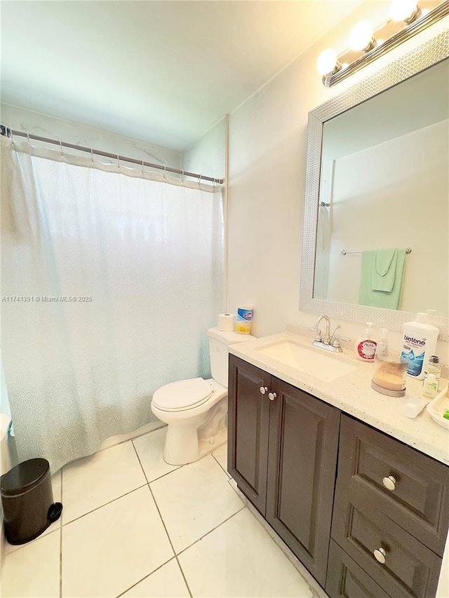 bathroom featuring tile patterned flooring, vanity, and toilet