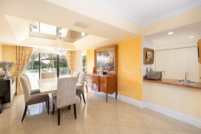 dining area featuring sink, crown molding, an inviting chandelier, radiator heating unit, and a tray ceiling