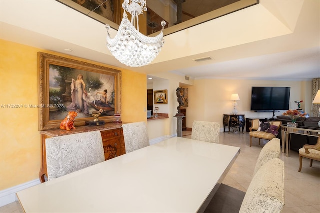 tiled dining room featuring an inviting chandelier