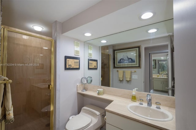 bathroom featuring walk in shower, vanity, and toilet