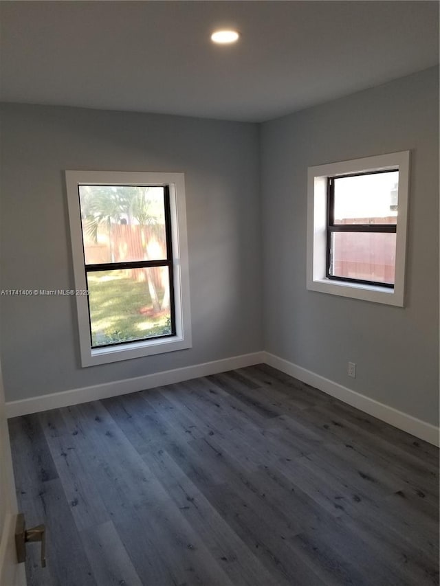 spare room featuring dark hardwood / wood-style flooring