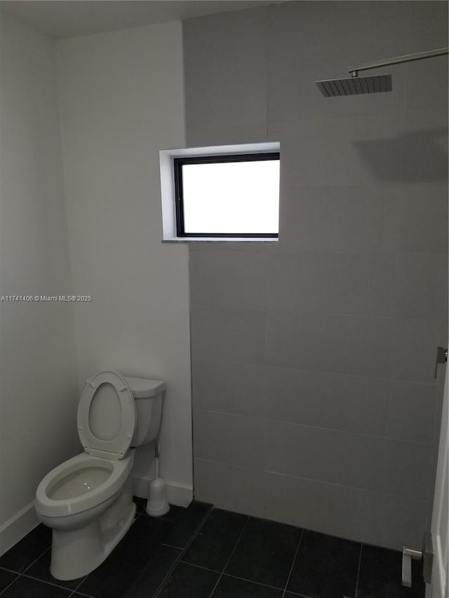 bathroom with tile patterned flooring and toilet