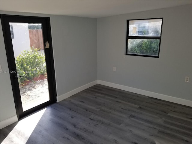 unfurnished room with dark wood-type flooring