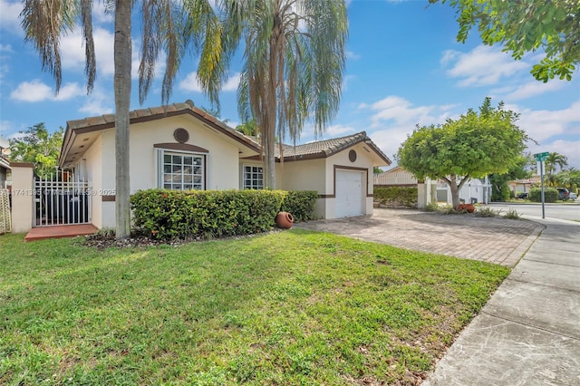 view of front of property with a garage and a front yard