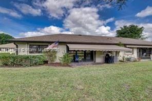 rear view of house with a yard