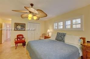 bedroom with ceiling fan and a closet