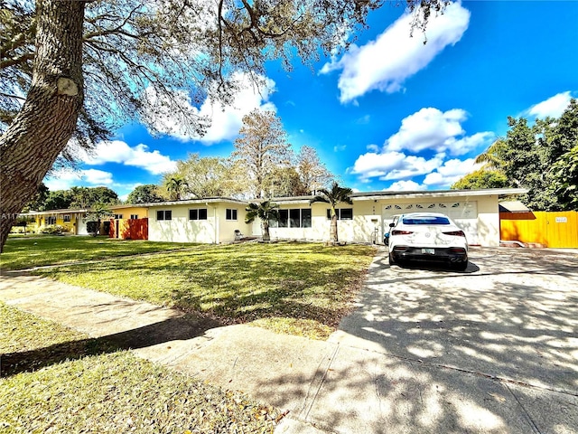 view of front of home featuring a garage and a front lawn