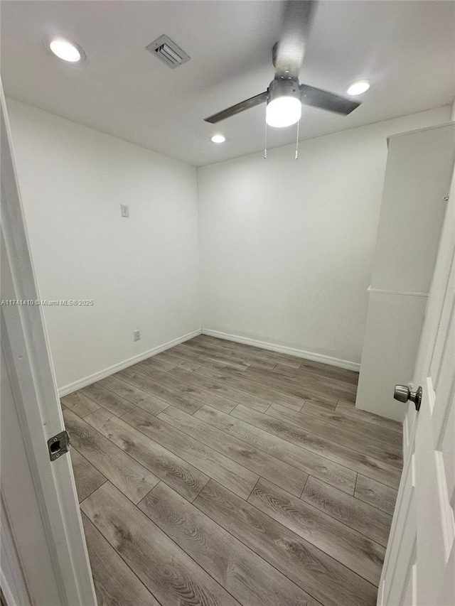 spare room featuring ceiling fan and light hardwood / wood-style floors