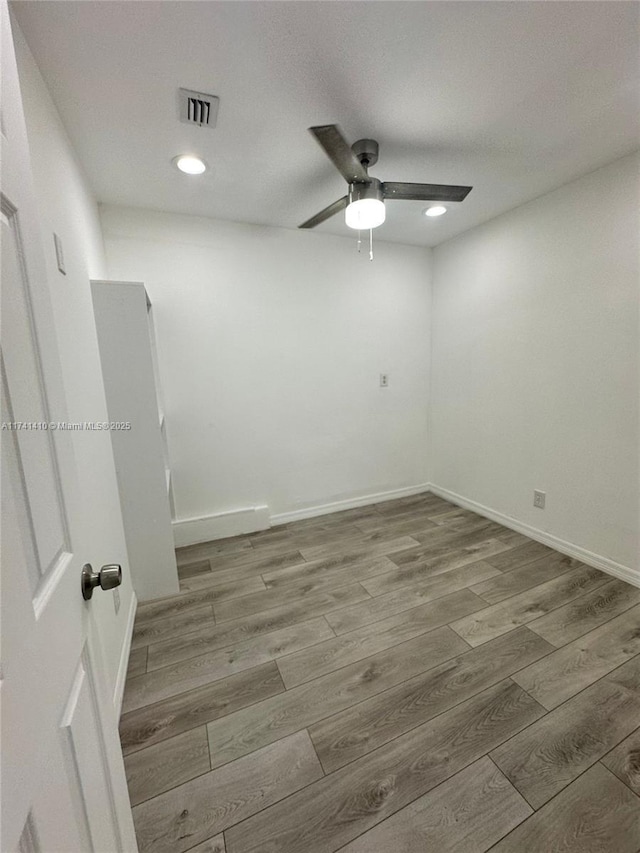 unfurnished room with hardwood / wood-style flooring and ceiling fan