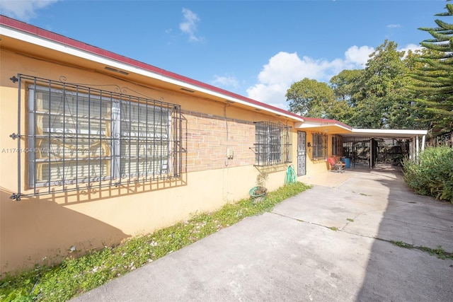 view of home's exterior featuring a carport