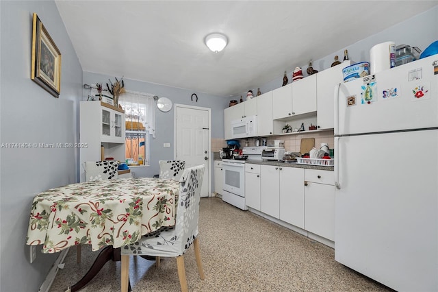 kitchen with tasteful backsplash, white cabinetry, and white appliances