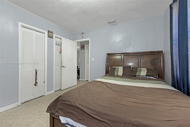 bedroom with two closets