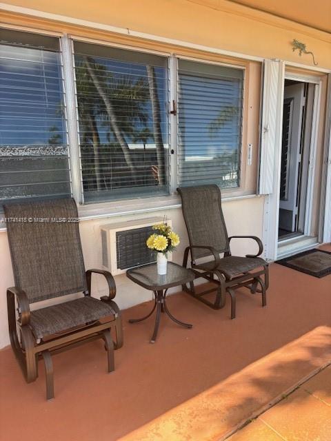 view of patio featuring a wall unit AC