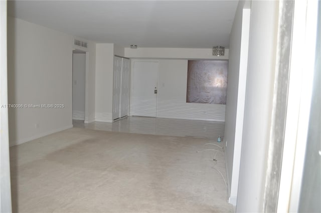 carpeted spare room with visible vents