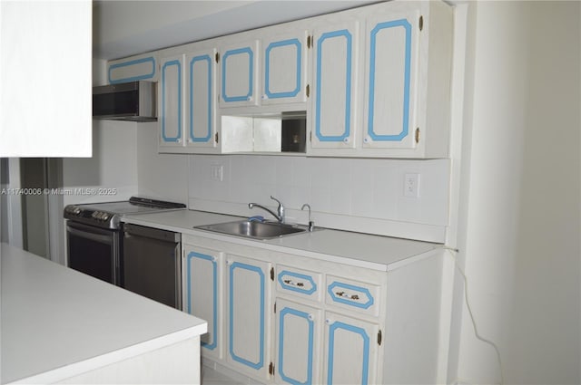 kitchen with stainless steel microwave, a sink, backsplash, light countertops, and electric range