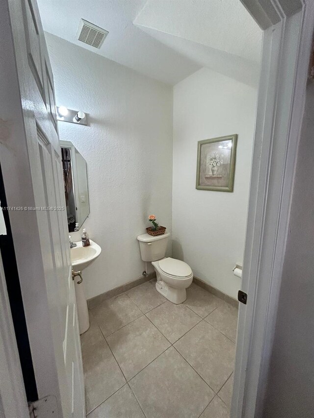 bathroom featuring tile patterned floors and toilet