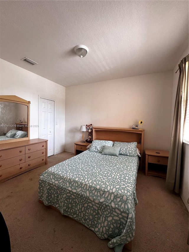 carpeted bedroom with a textured ceiling