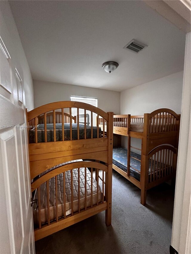 bedroom featuring dark colored carpet