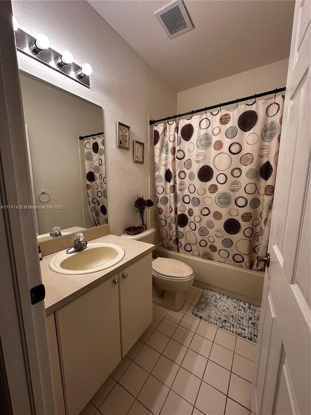 full bathroom with tile patterned flooring, vanity, shower / tub combo, toilet, and a textured ceiling