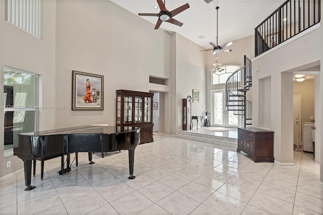 entryway featuring ceiling fan and a high ceiling