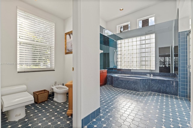 bathroom featuring independent shower and bath, a bidet, and toilet