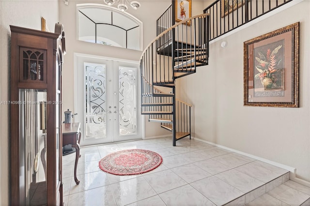 tiled entryway with french doors and a high ceiling