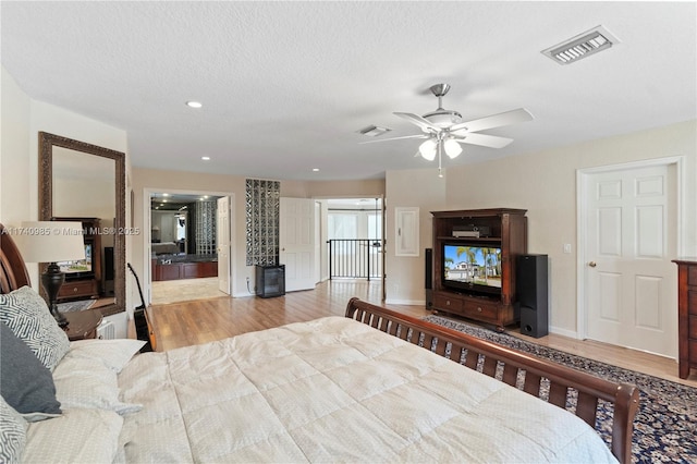 bedroom featuring a textured ceiling and light wood-type flooring