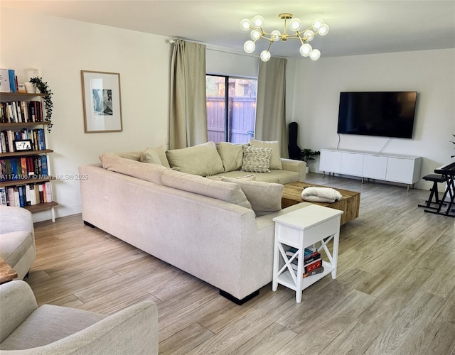 living room with wood-type flooring and a chandelier