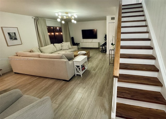 living room featuring hardwood / wood-style flooring and a notable chandelier