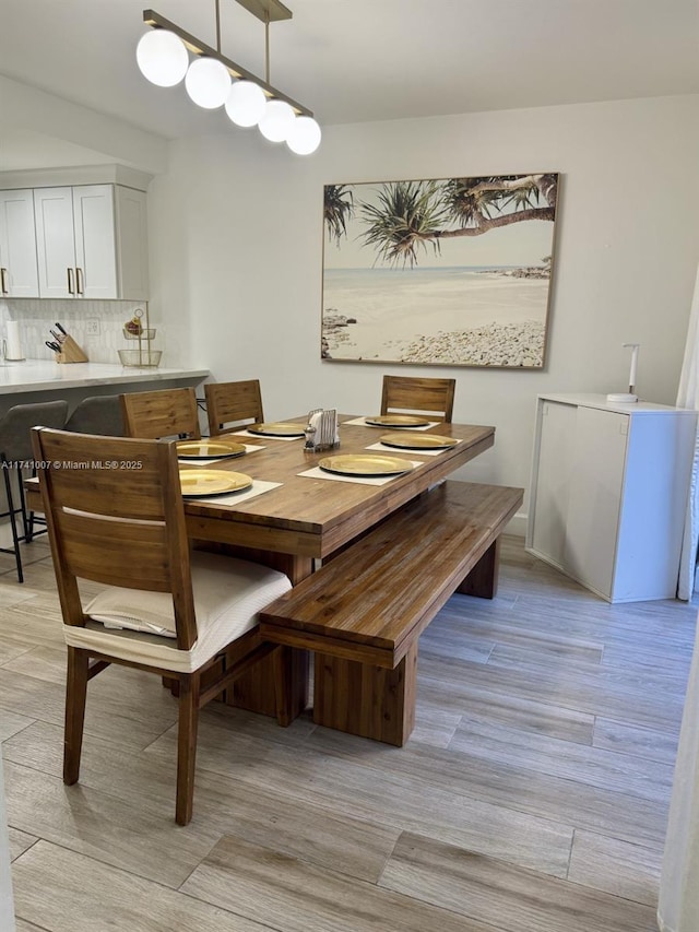 dining space featuring light wood-type flooring