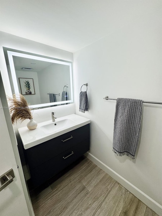 bathroom featuring vanity and hardwood / wood-style flooring