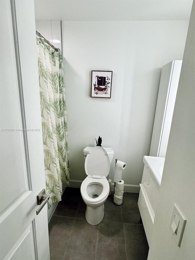 bathroom featuring tile patterned flooring, walk in shower, and toilet