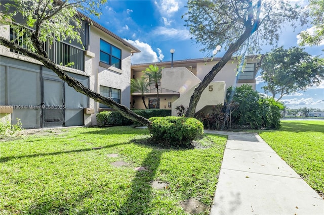 exterior space featuring a front yard and stucco siding