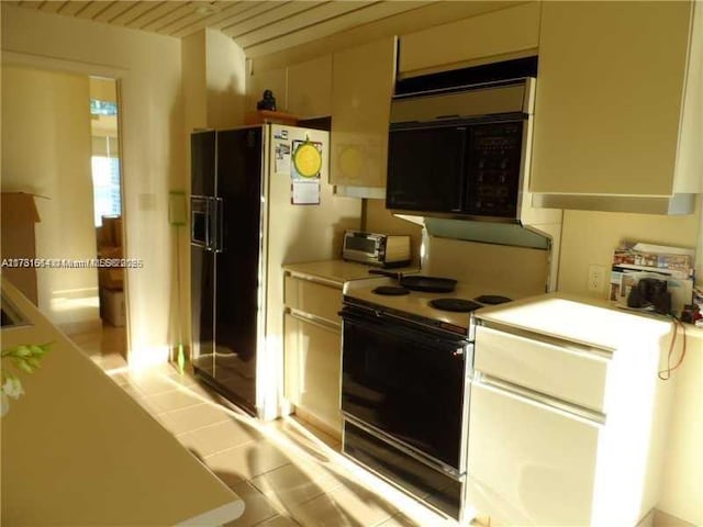 kitchen featuring light tile patterned floors and black appliances