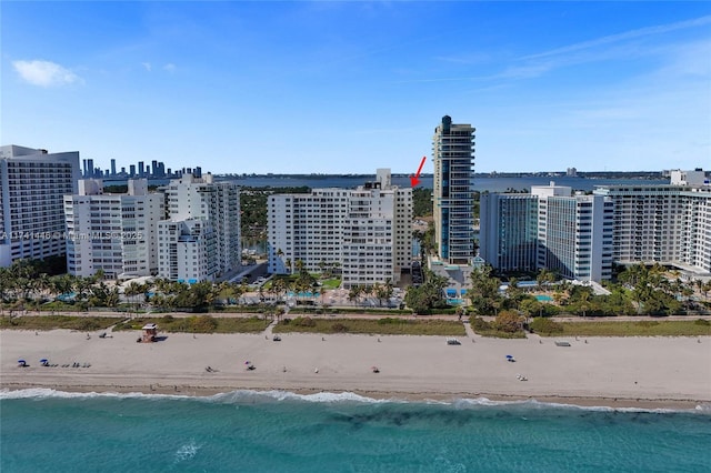 birds eye view of property featuring a beach view and a water view