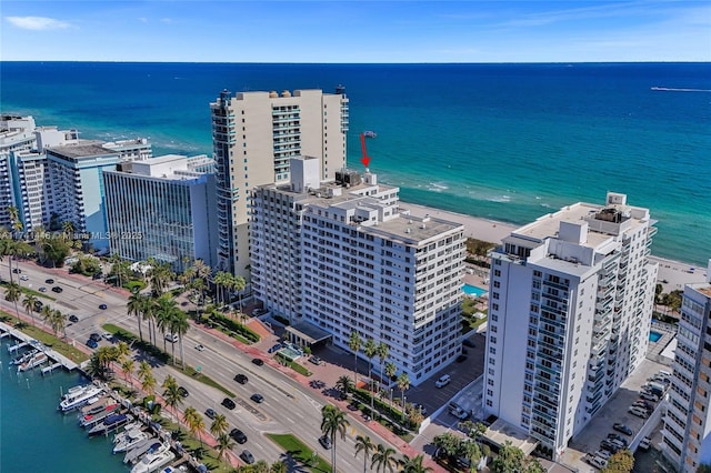 bird's eye view with a water view and a beach view