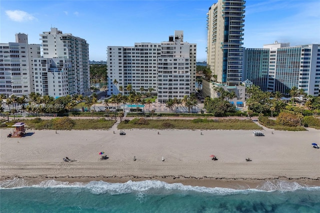 drone / aerial view with a water view and a beach view